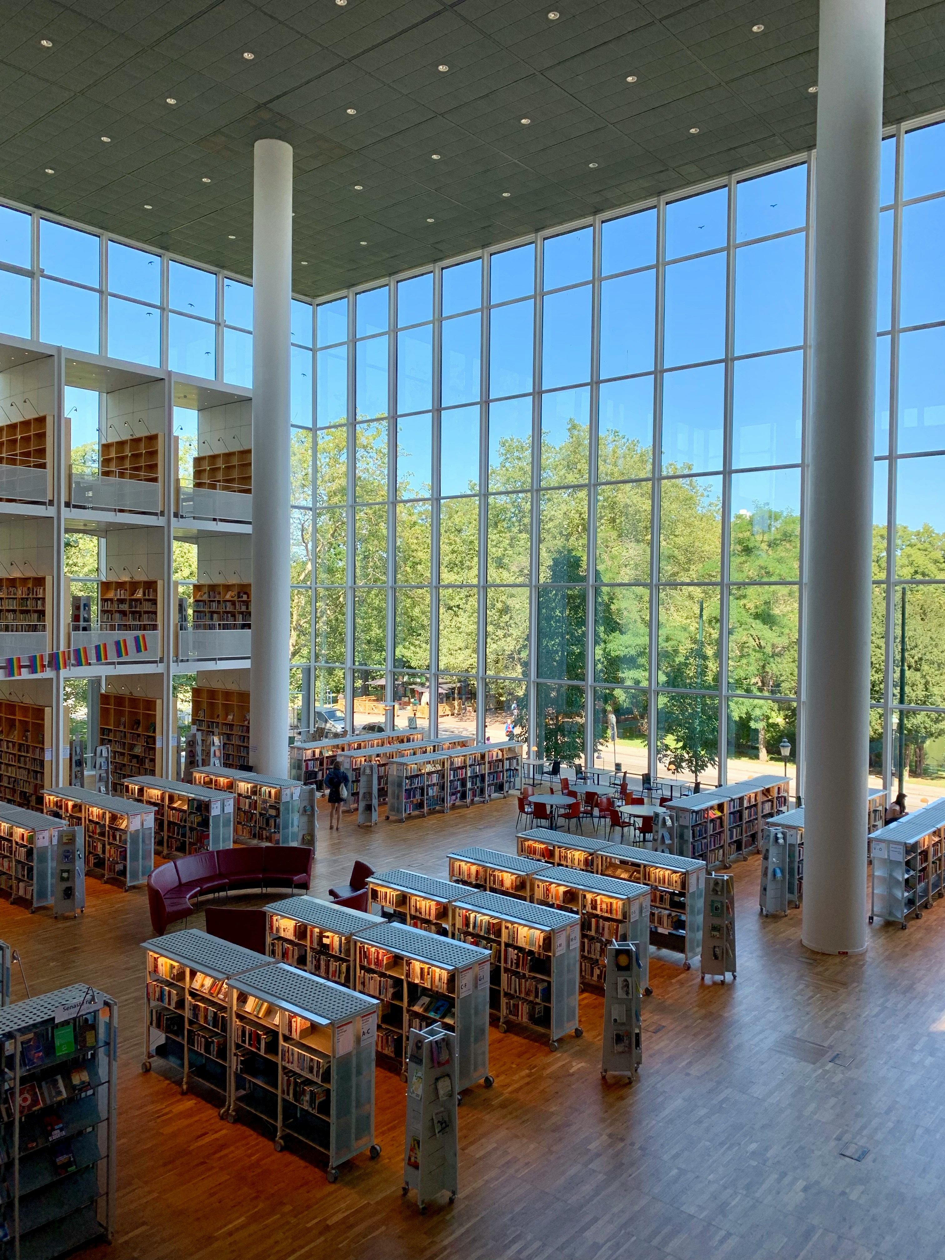 Looking down into a university library building with glass walls