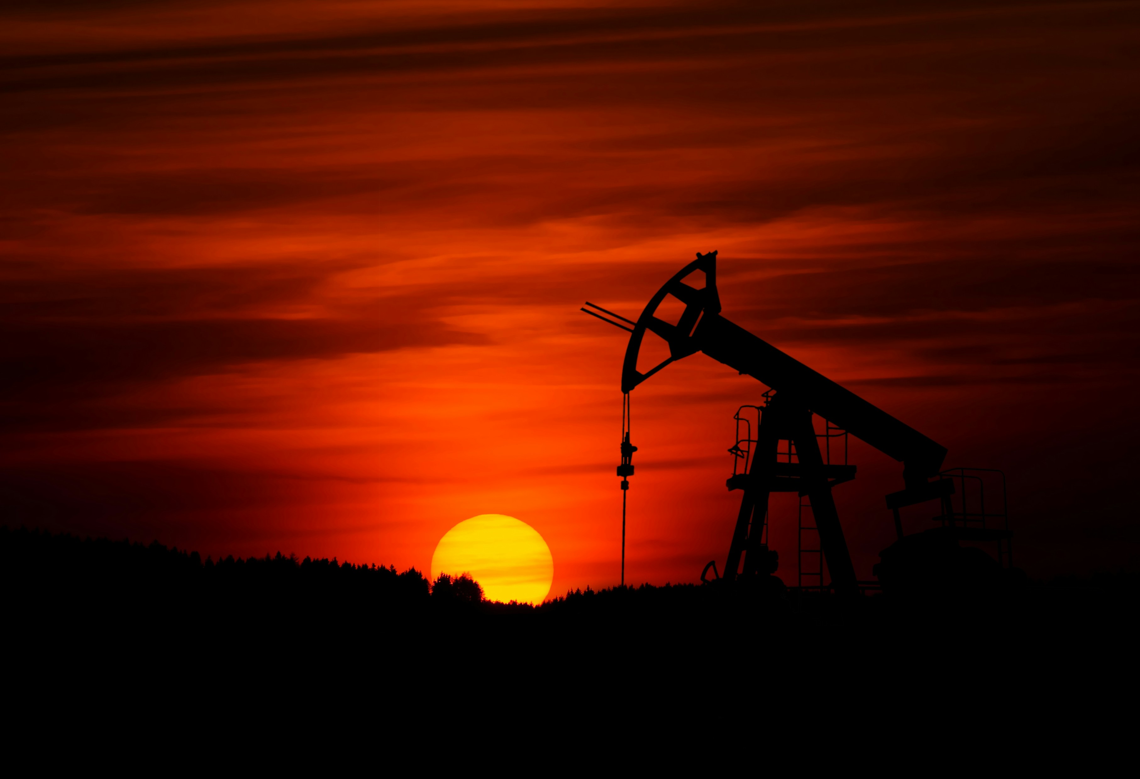 oil rig with brilliant red sunset in the background