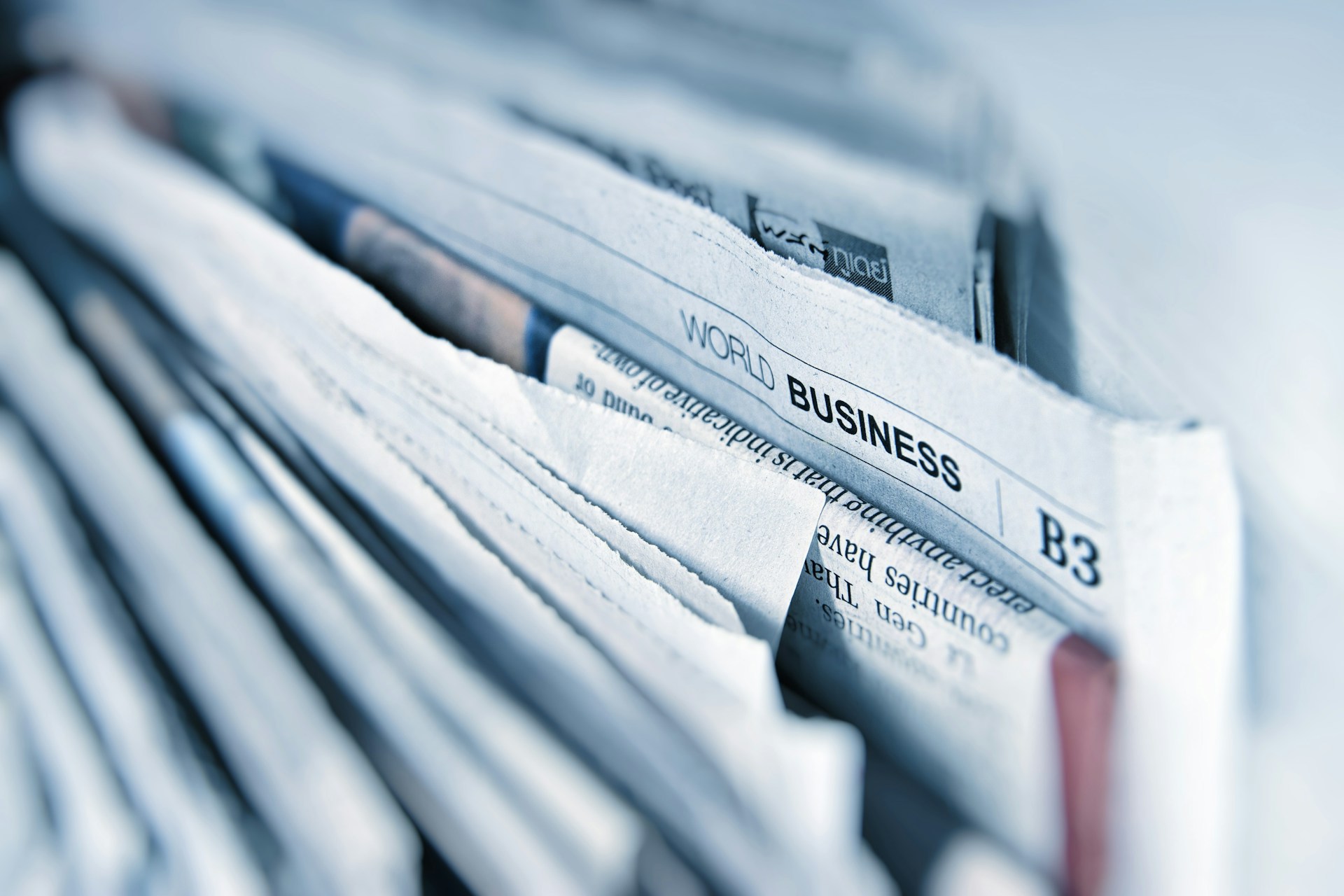  newspapers with business section pulled out.  reports, business, stats, publications