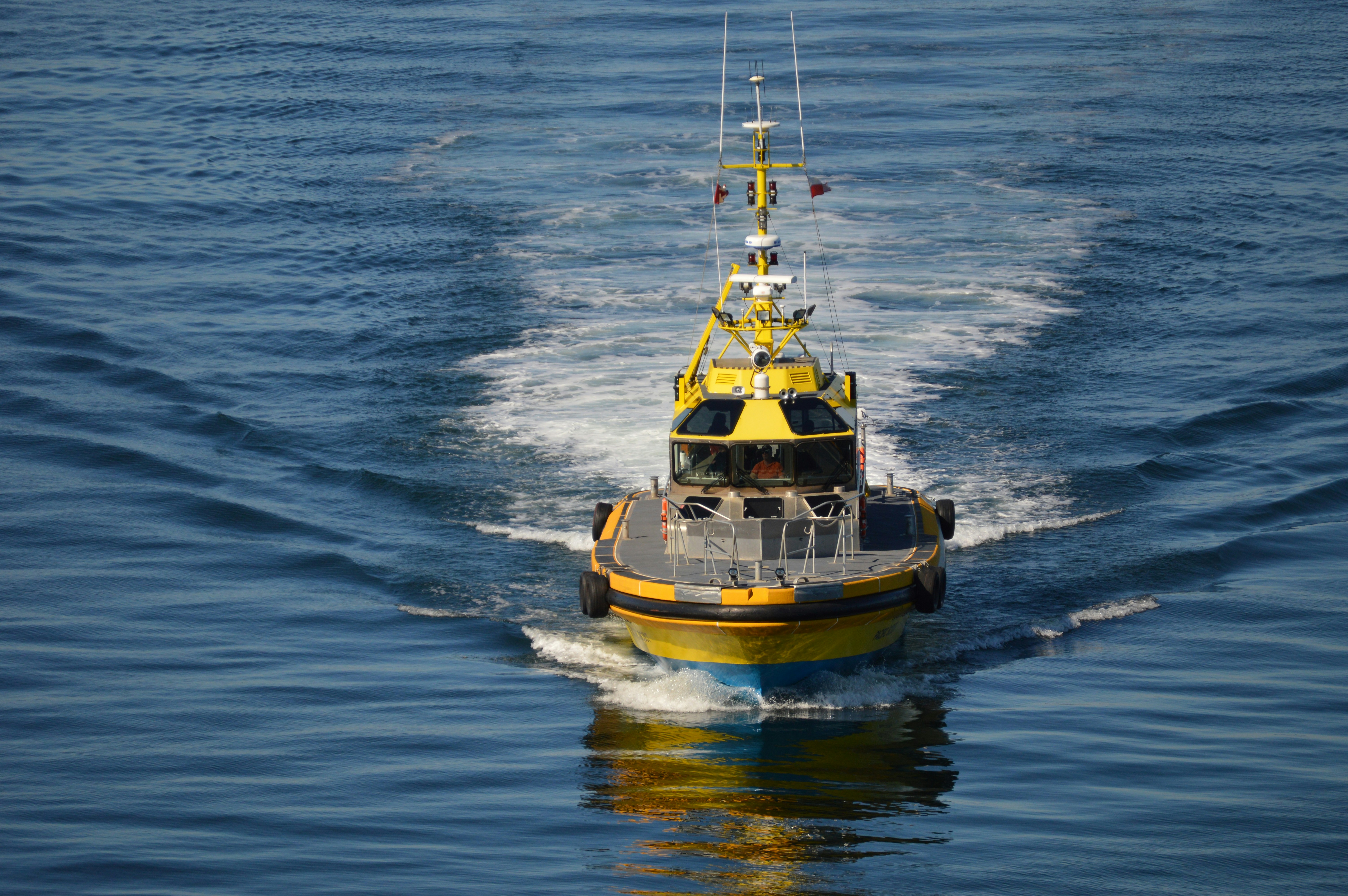 Yellow tug boat in blue waters