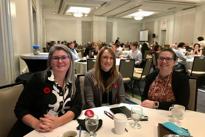 Executive Director Shannon Baikie pictured with Regional Manager , Client Services Donna Desmet, and Client Service Coordinator Heather Gordon seated at the 2022 Aspect conference