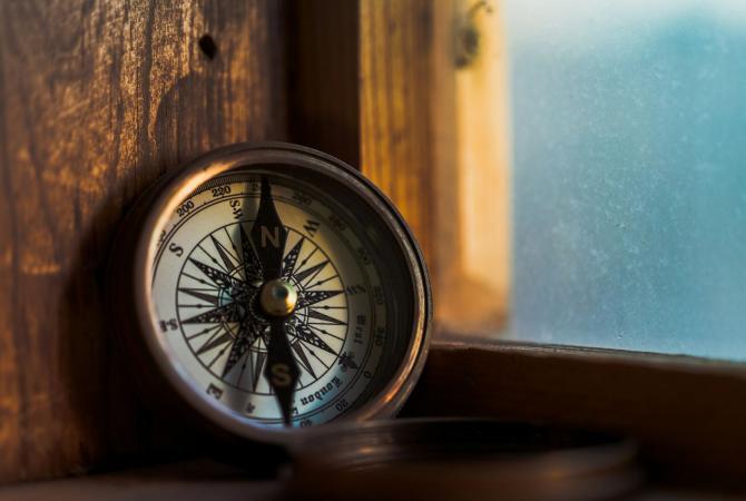 compass leaning against window frame 