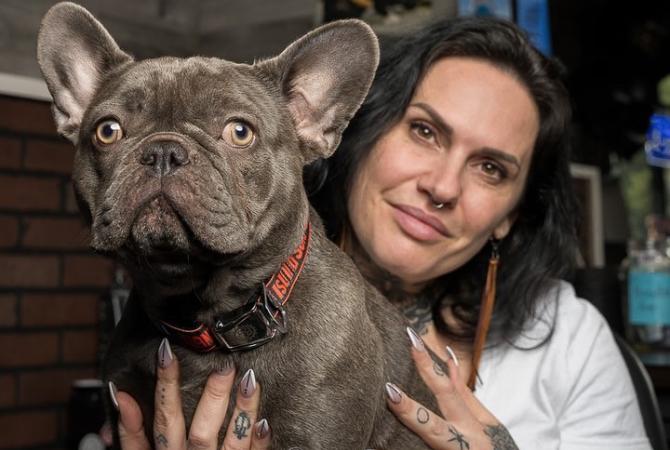 Photo of Leasha MacLennan, Owner/Operator of Black Creek Barber with their dog, Eddie